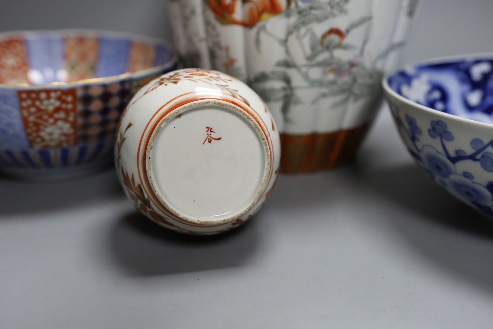 A Japanese kutani bottle vase, similar vase and cover (a.f), an Imari bowl and blue and white bowl. Largest 27cm